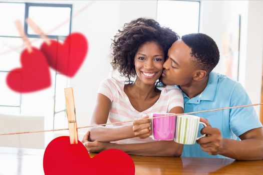 Romantic couple holding coffee mug at home