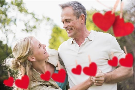 Romantic couple having fun with red hanging hearts