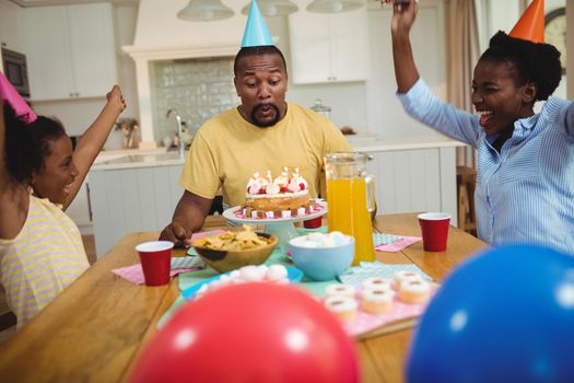 Family celebrating a birthday at home