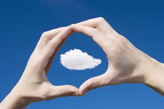 A caucasian man framing a cloud in his hands themes of point of view imagination scale