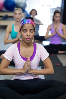 Group of women doing yoga in gym