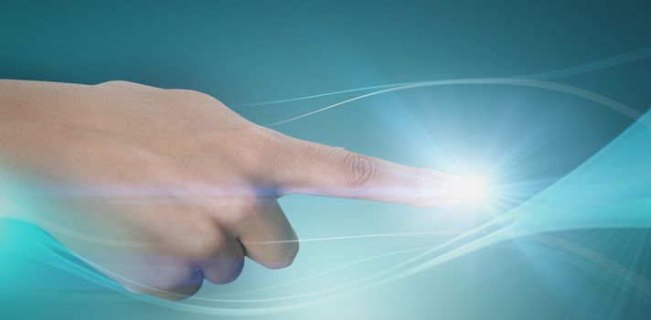 Close-up of human hand pointing against abstract glowing blue background