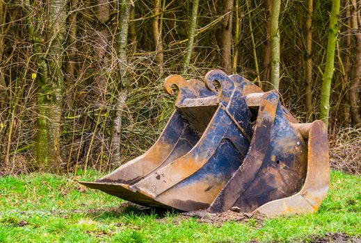 different sizes of scoops together on the ground, equipment for the excavator, earthmoving industry background