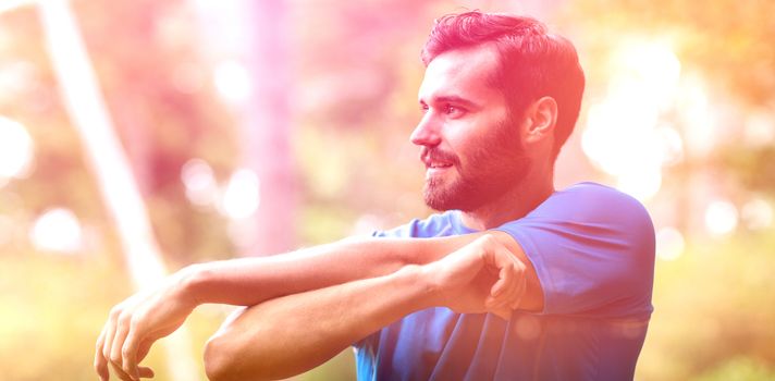 Smiling man exercising in forest