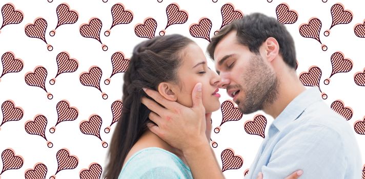 Attractive young couple about to kiss against background with hearts