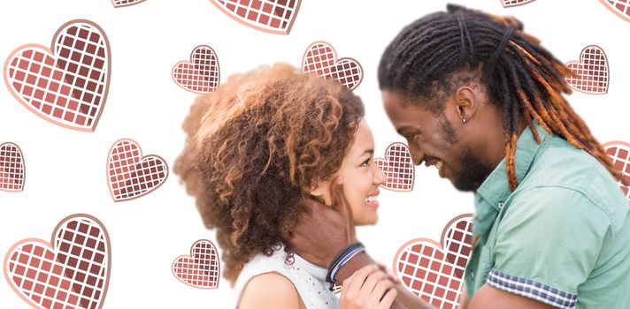 Young couple smiling and looking each others against background with hearts