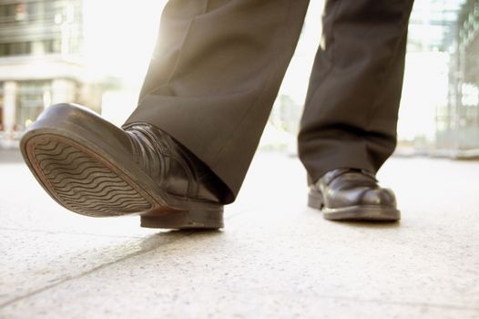 Businessman putting his best foot forward themes of beginnings leaving departure