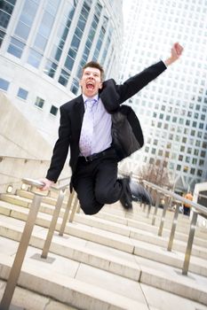 Happy caucasian businessman leaving the office jumping in the air themes of celebration joy winner