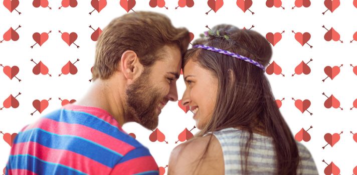 Happy young couple standing against background with hearts