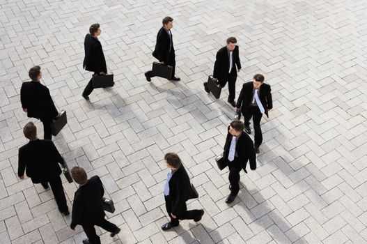 High view of a businessman walking round in circles themes of frustration loneliness repetition