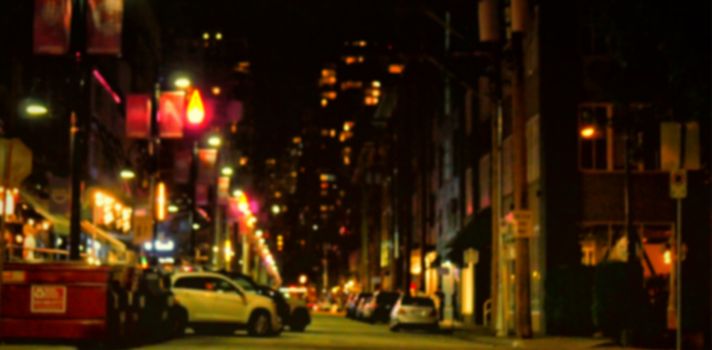 Car parked on street amidst buildings in city at night