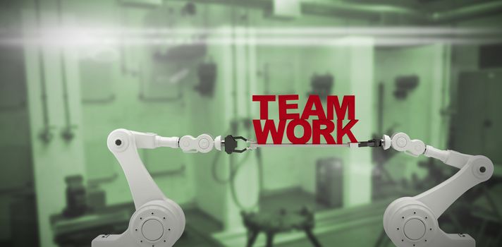 Robotic hand holding red team work text over white background against interior of factory 