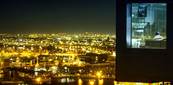 Aerial view of illuminated city against sky at night