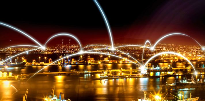 View of illuminated harbor against cityscape at night