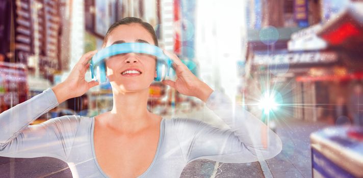 Smiling woman using virtual video glasses against blurry new york street