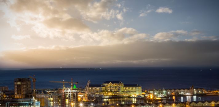 Illuminated buildings in city against sky