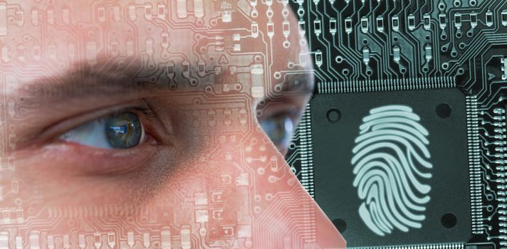 Man with green eyes against thumb print in circuit board