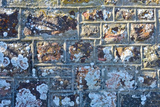 Old weathered mortar and stone block wall face, South Africa