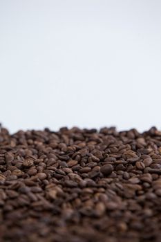 Roasted coffee beans on white background