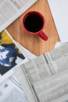 Coffee served in red mug on wooden table