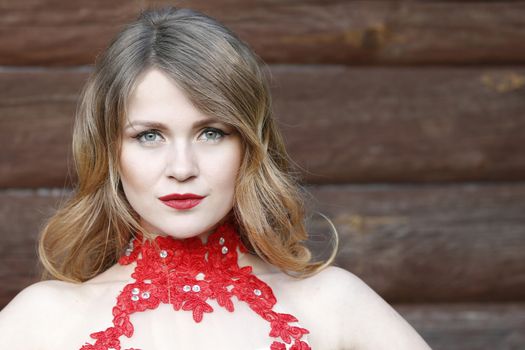 Portrait of a beautiful girl in a red dress.A woman in a red dress. A chic girl. A magnificent lady.