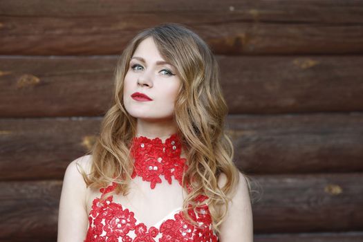 Portrait of a beautiful girl in a red dress.A woman in a red dress. A chic girl. A magnificent lady.