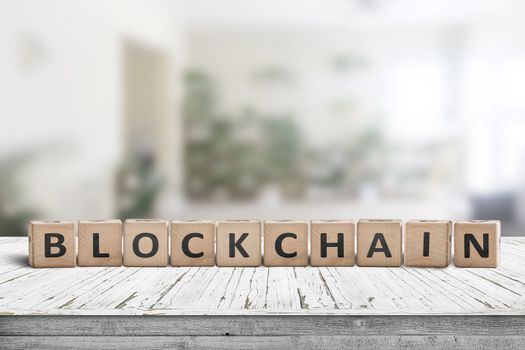 Blockchain sign made of wood on a desk in a bright living room