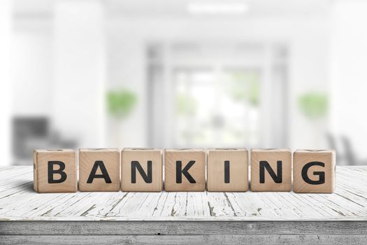 Banking sign on a wooden desk in a bright work environment