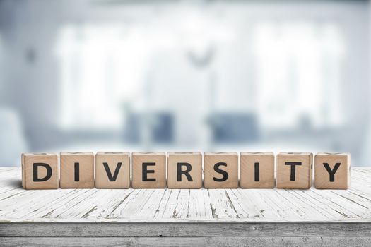 Diversity word sign on a wooden desk in a bright blue room