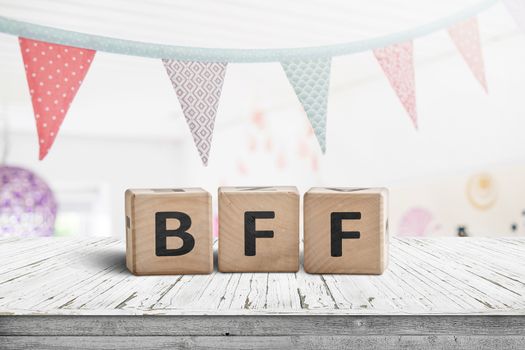 BFF greeting message made of wooden blocks with colorful flags hanging above