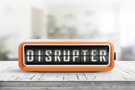 Disrupter alarm on a wooden table in a bright room with green plants in the background