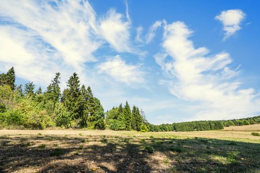 Summer landscape of a countryside valley in Germany with dry plains under a blue sky