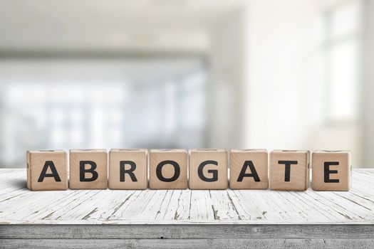Abrogate sign made of wooden blocks on a white desk in a bright living room