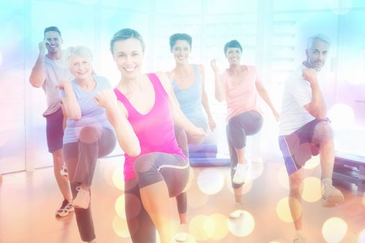 Smiling people doing power fitness exercise at yoga class against abstract background