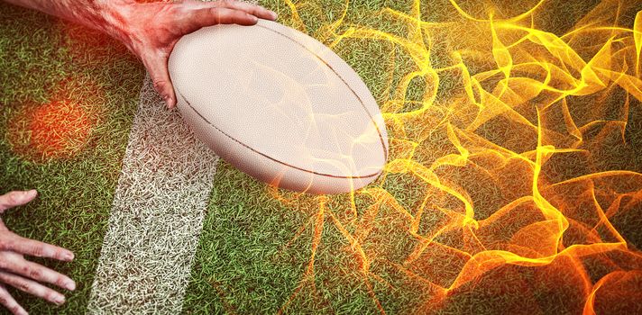 Abstract orange glowing black background against composite image of cropped image of a man holding rugby ball