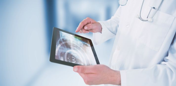 Doctor using digital tablet against dental equipment