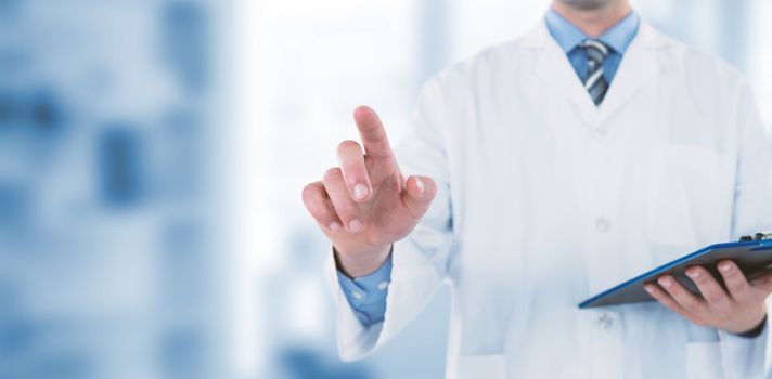 Doctor holding clipboard while touching transparent interface against dental equipment