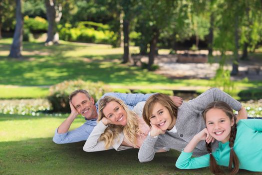 Digital composite of family laying on the grass