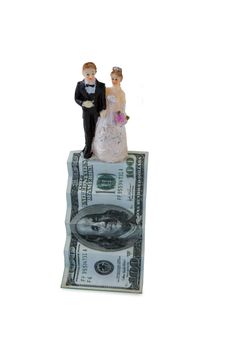 Wedding couple figurines on US dollar banknote against white background