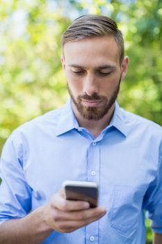 Man using mobile phone in a park