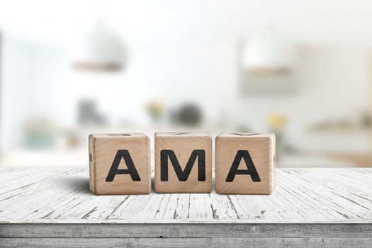 AMA ask me anything message made of wood in a bright room on a desk