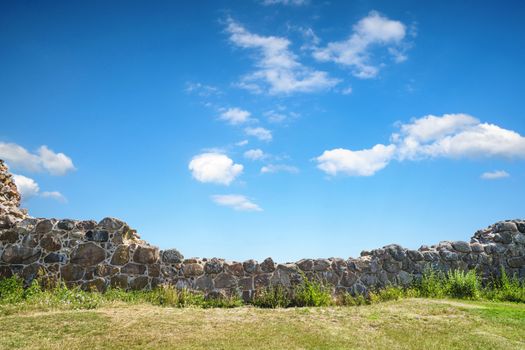 Stone wicket on a meadow in the summer under a blue sky in a rural countryside