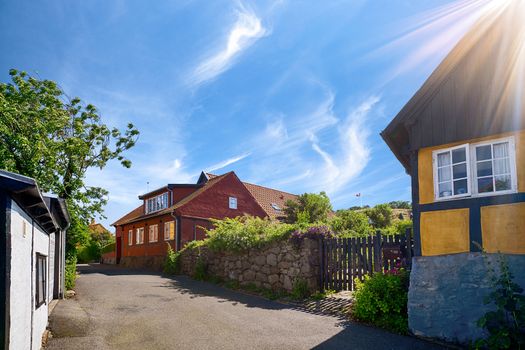 Idyllic danish street with old buildings in vintage colors under a blue sky in the summer