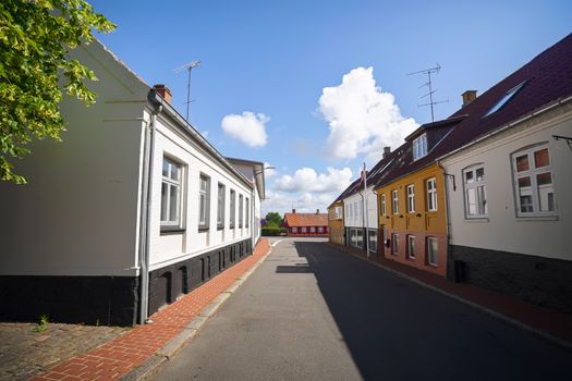 Empty street in a small danish village with colorful buildings in the summer