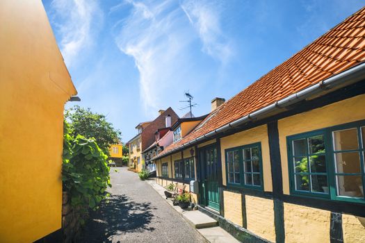 Idyllic village with yellow buildings under a blue sky in the summer