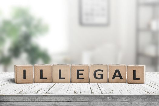 Illegal message on a wooden desk in a bright living room in daylight