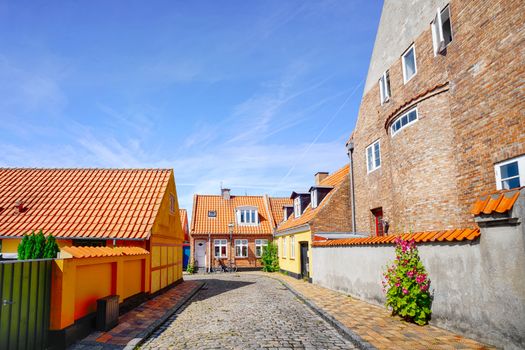 Colorful danish street in the summer with small houses under a blue sky