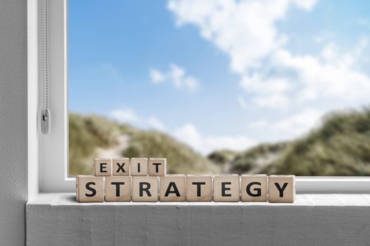 Exit strategy sign in a window with a view to beautiful nature under a blue sky