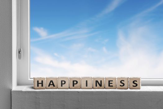 Happiness sign in a window sill with a view to ablue sky on a bright day