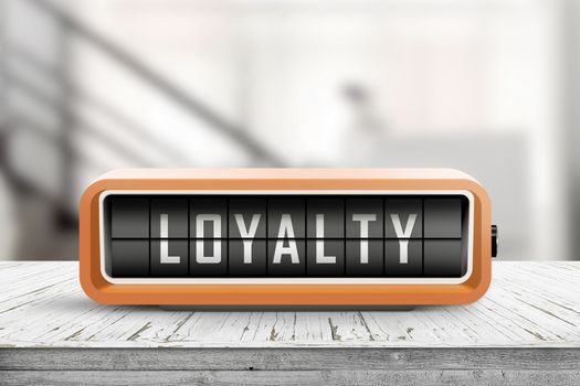 Loyalty message on a retro alarm clock in orange color in a bright room